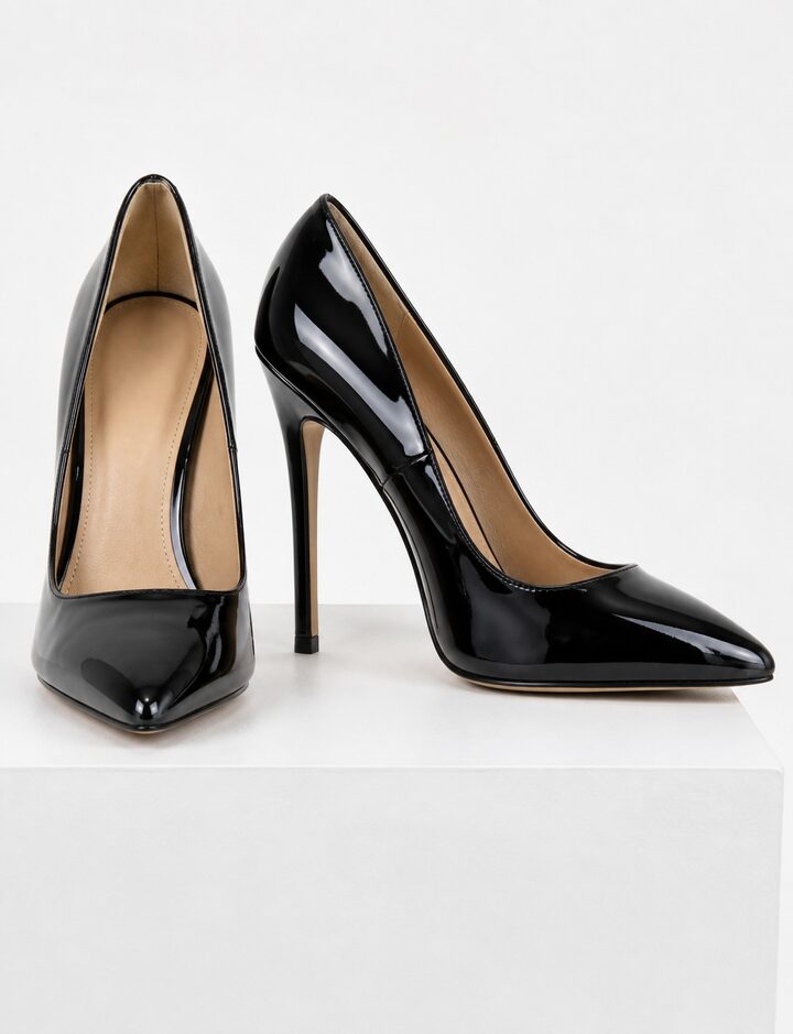 A pair of black patent pointed-toe court heels