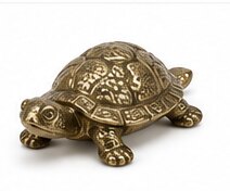 A decorative brass tortoise ornament