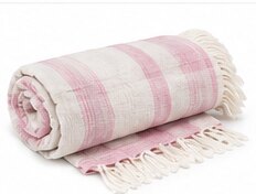 A rolled pink and white striped cotton throw with tassels